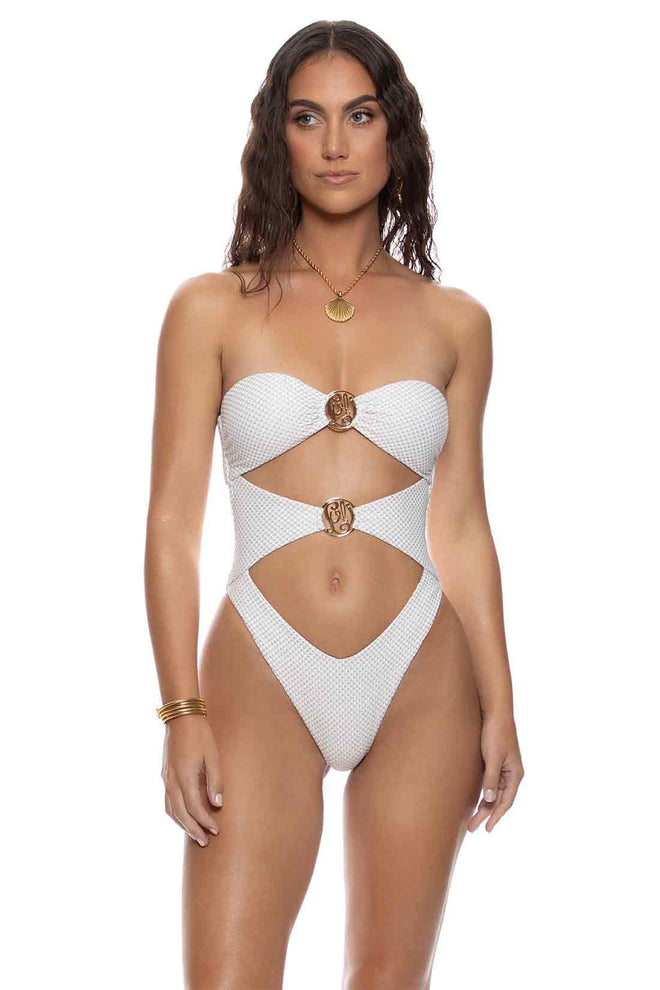 Woman wearing a white cut-out swimsuit on a white background