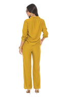 Woman wearing a mustard yellow outfit on a white background