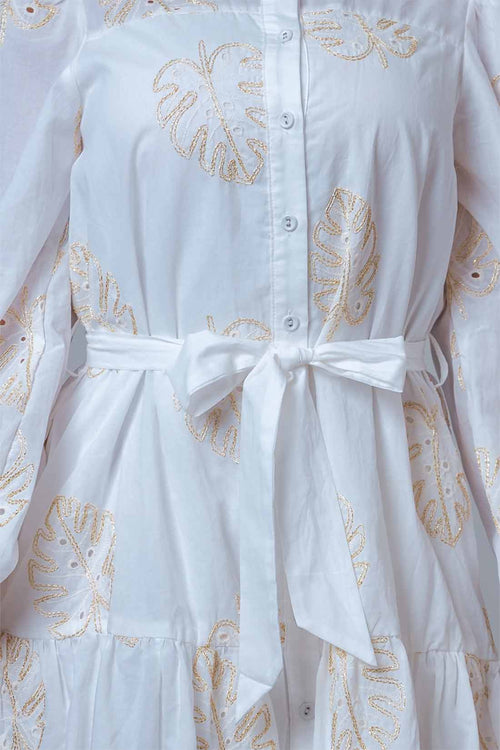 White dress with gold embroidery and a bow detail