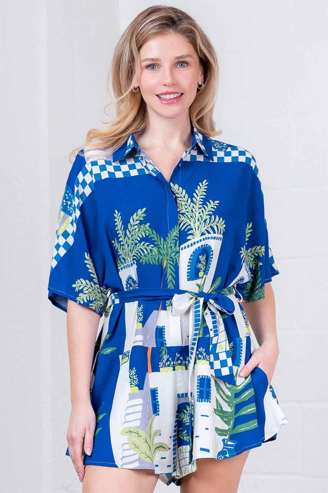 Woman wearing a blue patterned dress with a white background