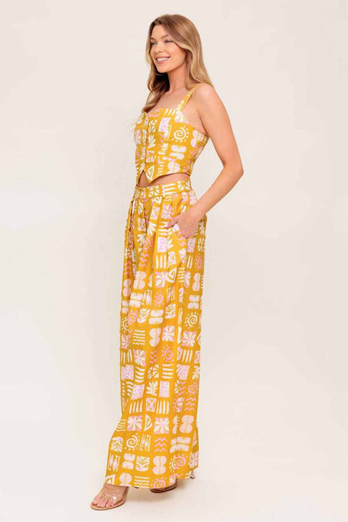 Woman wearing a yellow patterned dress on a white background