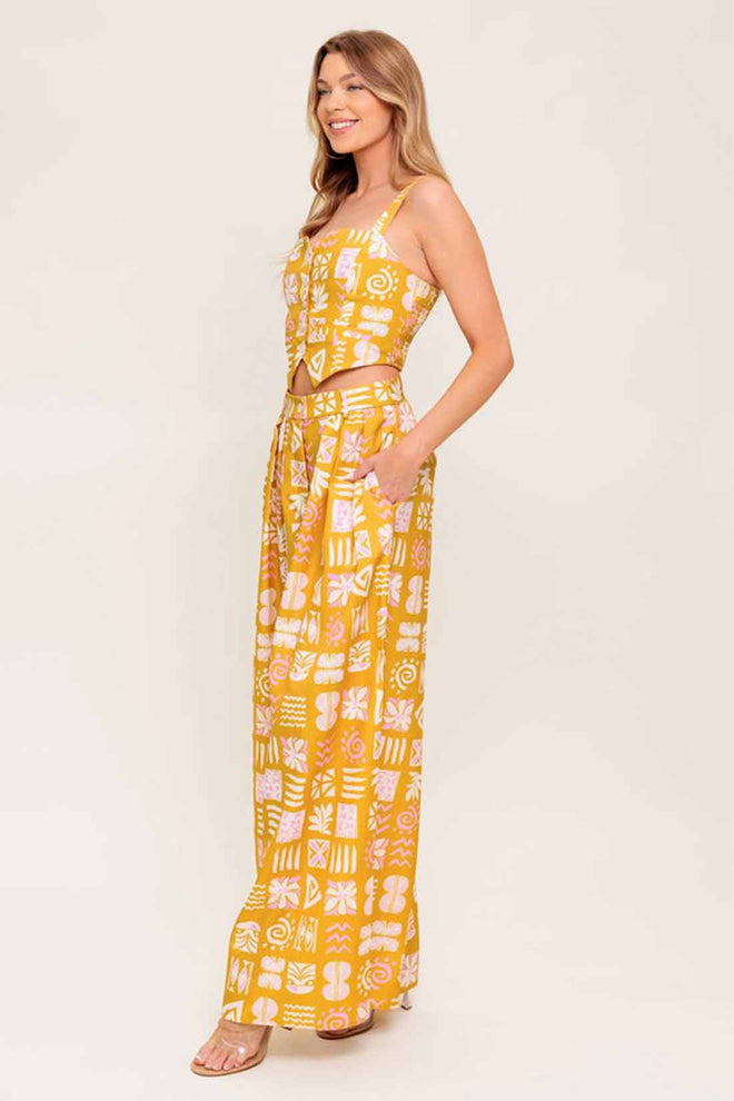 Woman wearing a yellow patterned dress on a white background