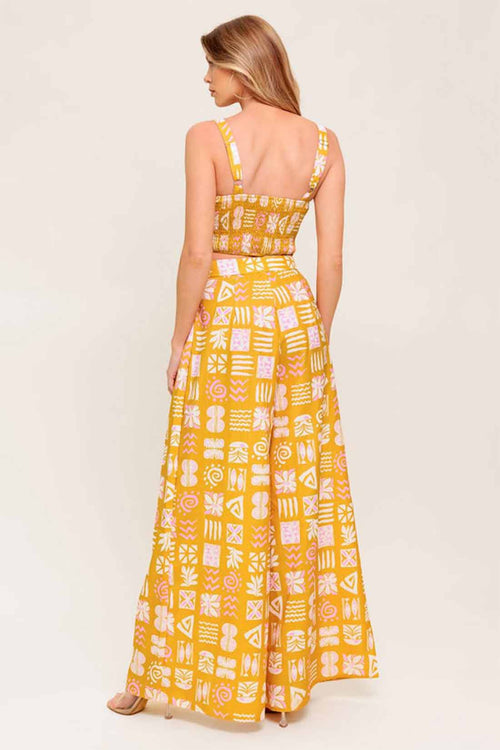 Woman wearing a yellow patterned dress on a white background