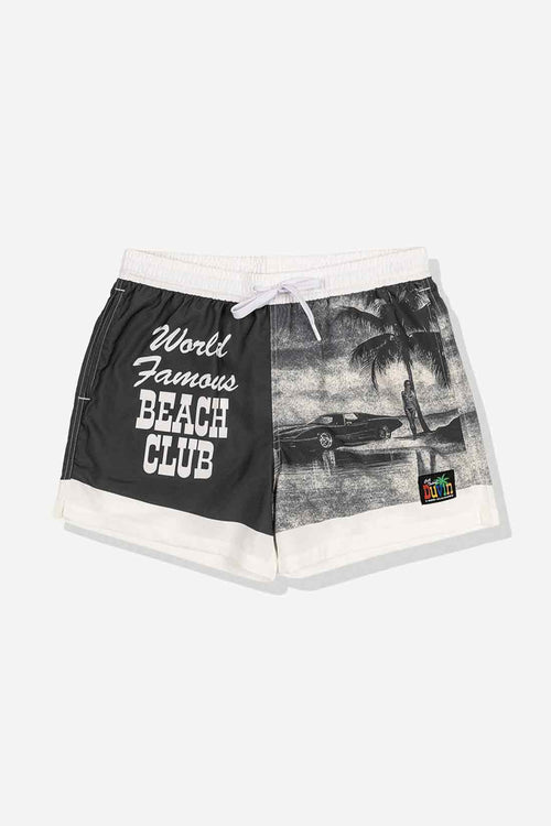 Black and white shorts with 'World Famous Beach Club' text and tropical graphic on a light gray background