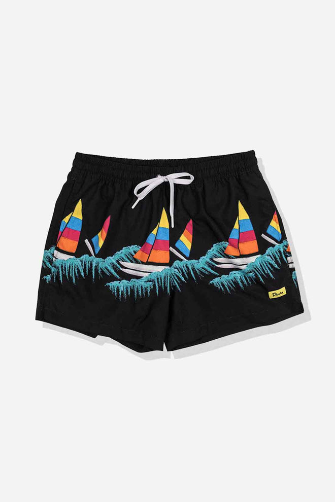 Black shorts with colorful sailboat design on a light gray background